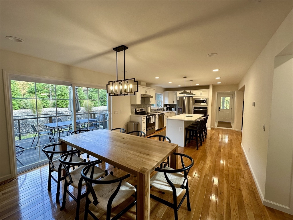 151 Tashmoo Avenue Tisbury, MA 02568 - Photo 9 of 28 a view of a dining room with furniture wooden floor and chandelier