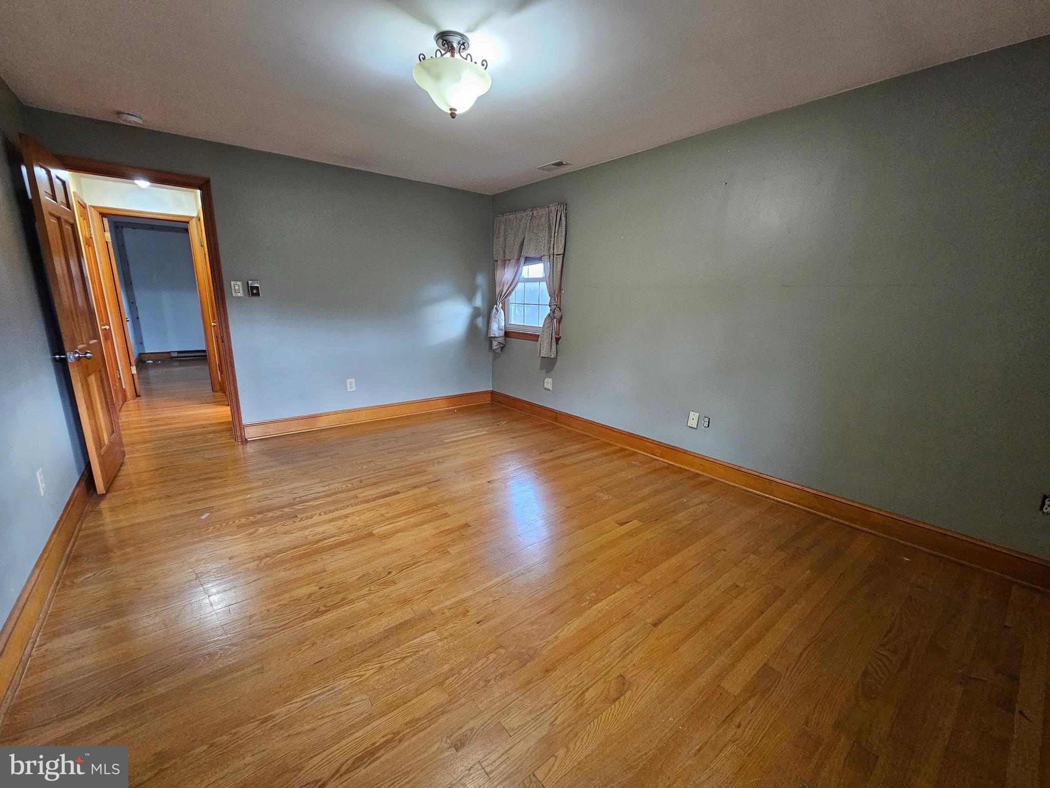 615 Villa Avenue, Unit A Front Royal, VA 22630 - Photo 21 of 29 an empty room with wooden floor and windows