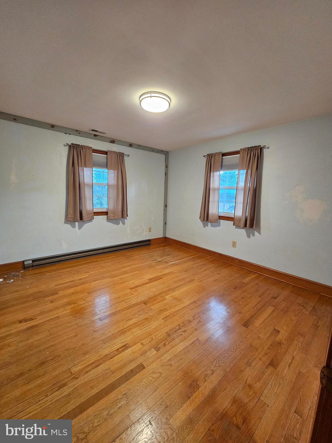615 Villa Avenue, Unit A Front Royal, VA 22630 - Photo 27 of 29 an empty room with wooden floor and windows