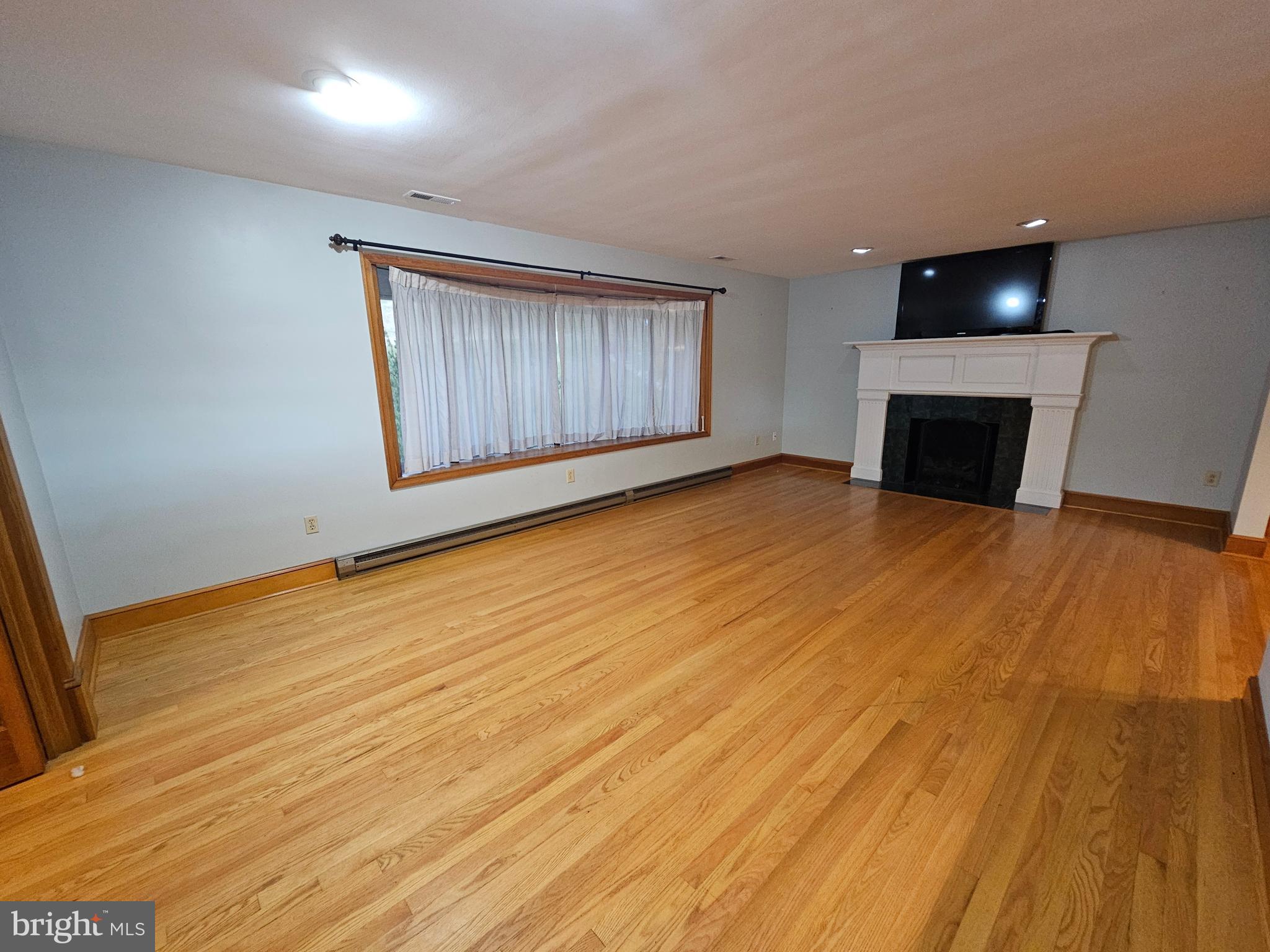 615 Villa Avenue, Unit A Front Royal, VA 22630 - Photo 8 of 29 a view of an empty room with wooden floor and a window