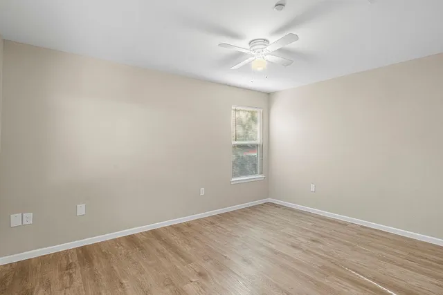 wooden floor in an empty room with a window