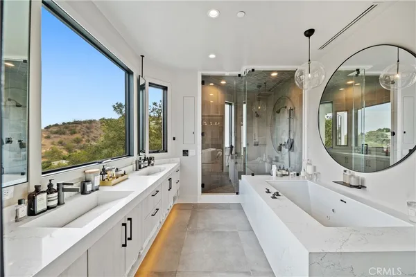 wooden floor with view of bathroom