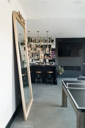 a living room with furniture a chandelier and a large window