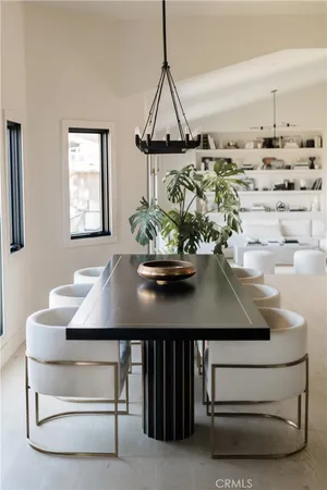 a kitchen with stainless steel appliances kitchen island granite countertop a table and a chair