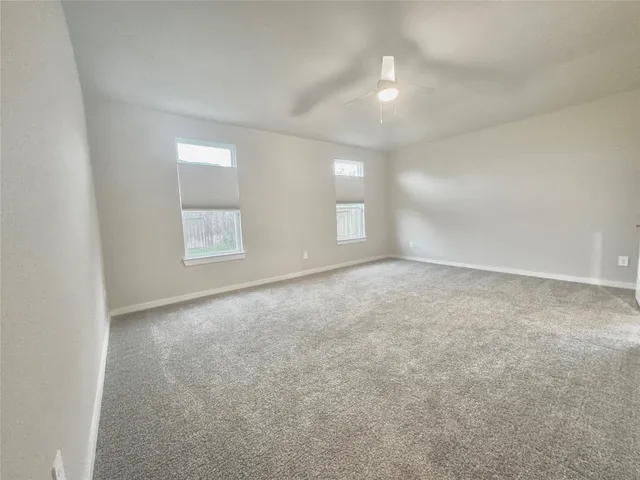 an empty room with windows and entrance