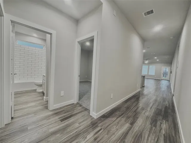 a view of hallway with wooden floor