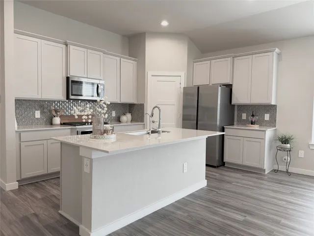 a kitchen with a sink cabinets and stainless steel appliances