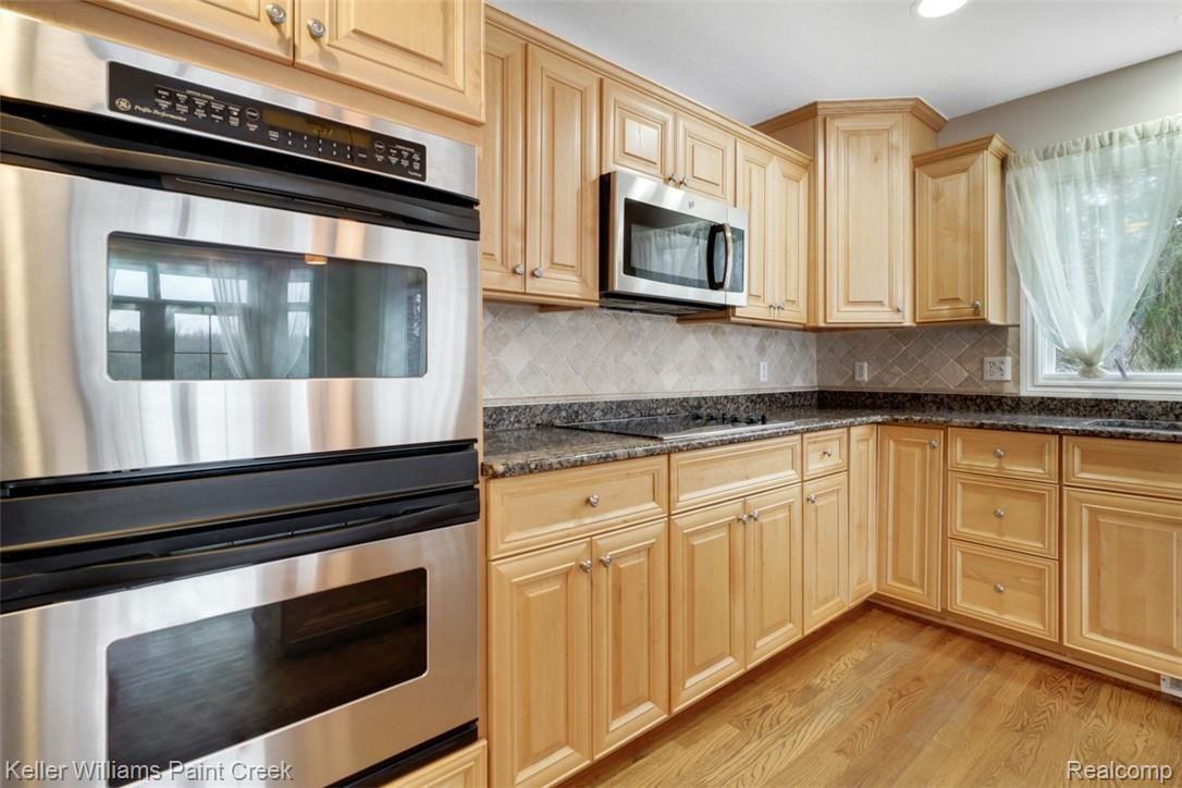 1400 Army Road Leonard, MI 48367 - Photo 22 of 56 Tons of cabinets for storage and a double oven.