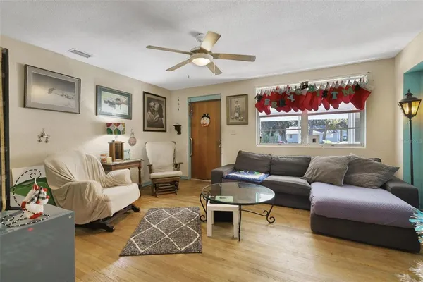 a living room with furniture ceiling fan and a rug