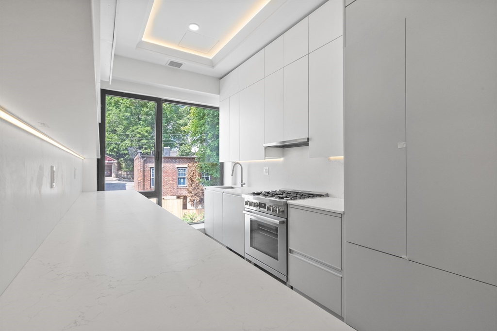 1578 Beacon Street, Unit PH2 Brookline, MA 02446 - Photo 1 of 18 a kitchen with white cabinets and white appliances