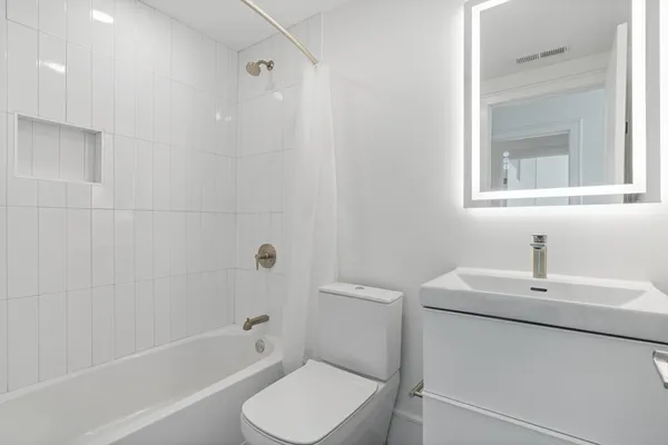 a bathroom with a sink toilet and shower