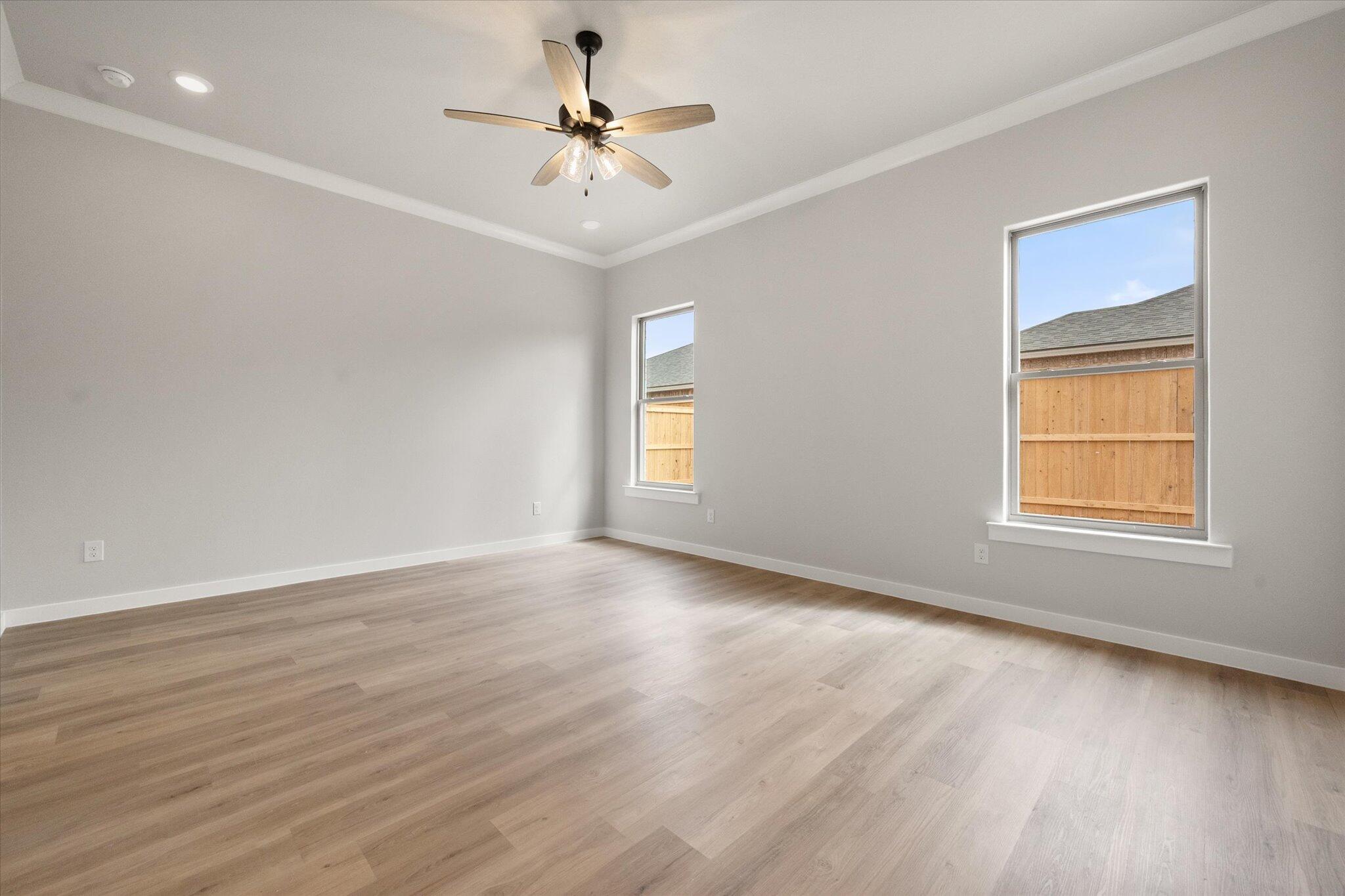 6827 54th Street Lubbock, TX 79407 - Photo 13 of 23 a view of an empty room with a window and wooden floor