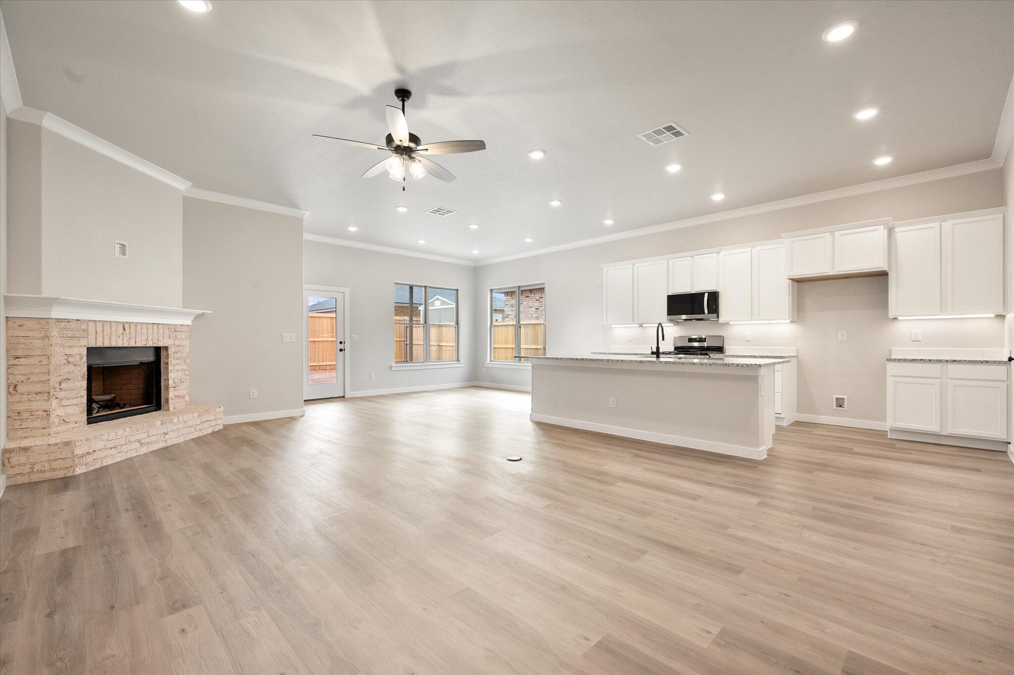 6827 54th Street Lubbock, TX 79407 - Photo 2 of 23 a view of kitchen with granite countertop cabinets and wooden floor