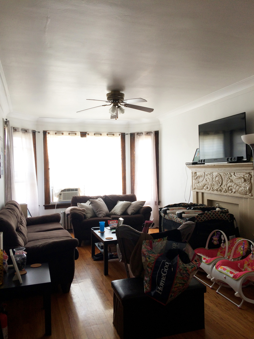 11432 South Indiana Avenue Chicago, IL 60628 - Photo 11 of 21 a living room with furniture fireplace and a large window