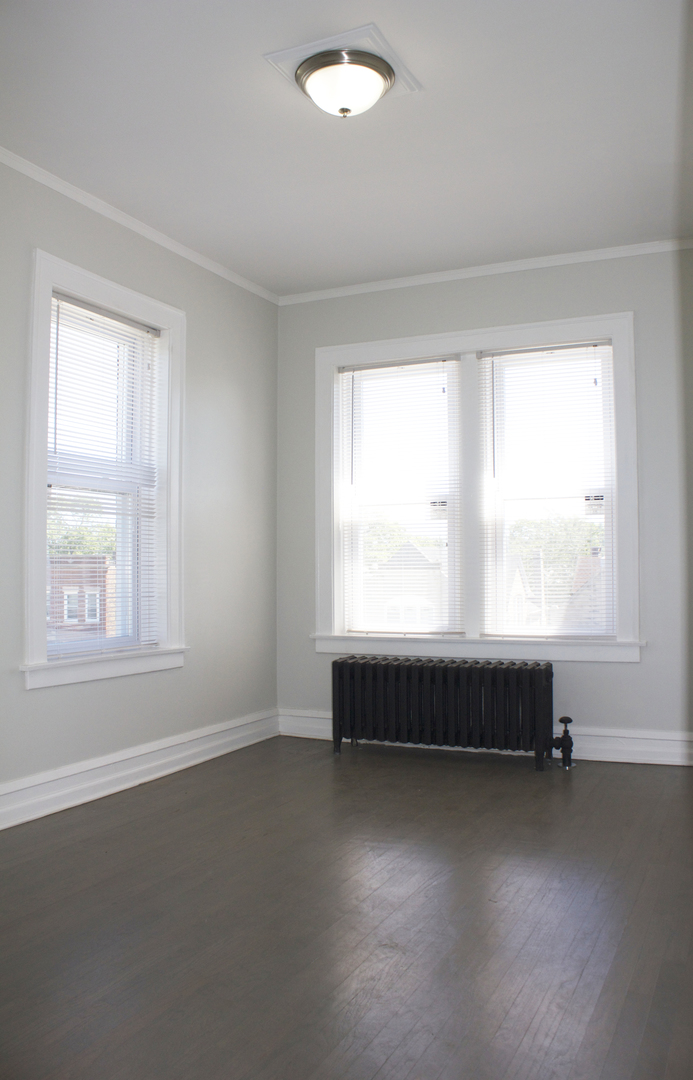 11432 South Indiana Avenue Chicago, IL 60628 - Photo 4 of 21 an empty room with windows
