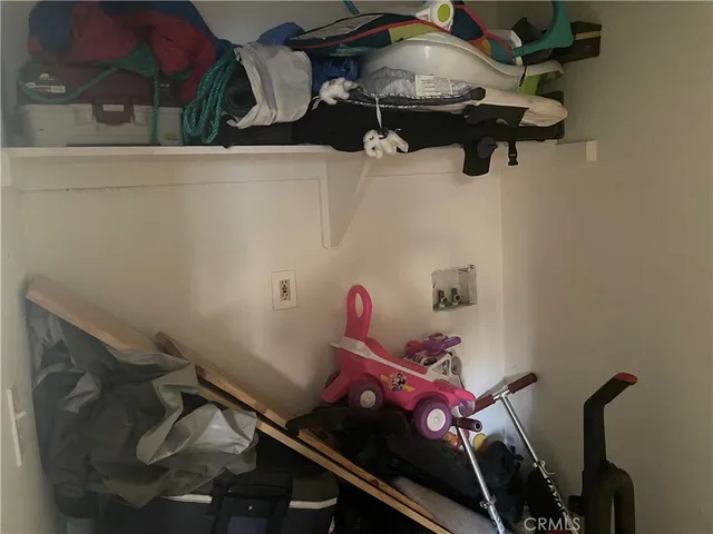 a white toilet sitting next to a bathroom sink and a mirror