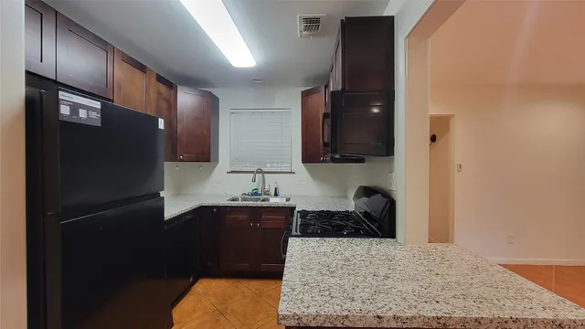 a kitchen with a refrigerator and a sink