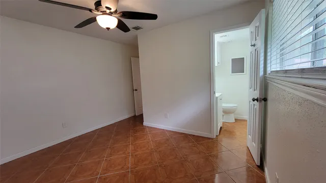 en empty room with a fan and a fan