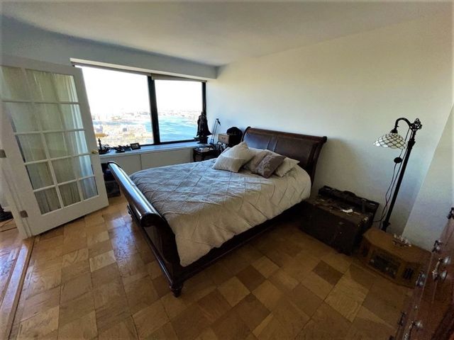 a bed sitting in a bedroom next to a window