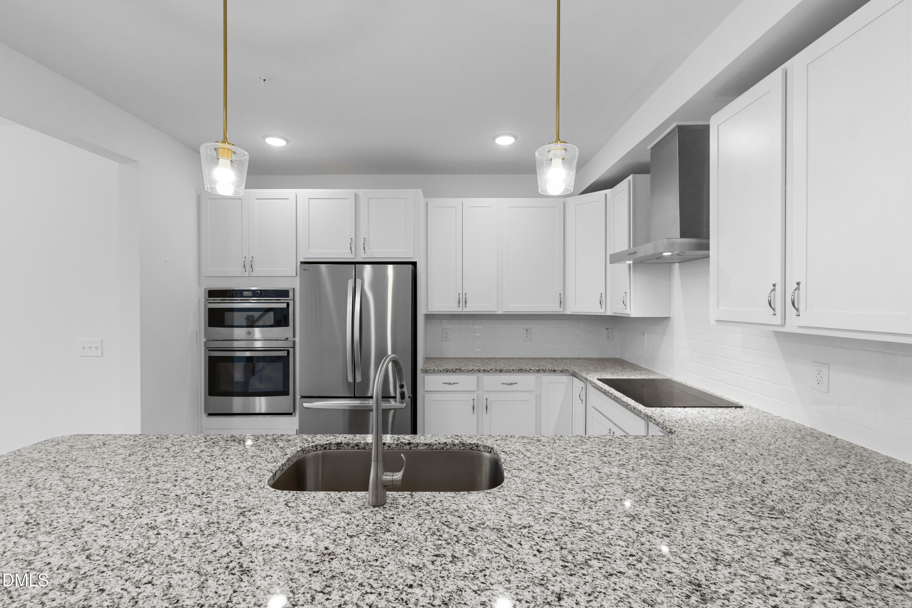 1206 Coach Station Alley Raleigh, NC 27601 - Photo 11 of 38 a kitchen with stainless steel appliances granite countertop a sink a stove and a refrigerator