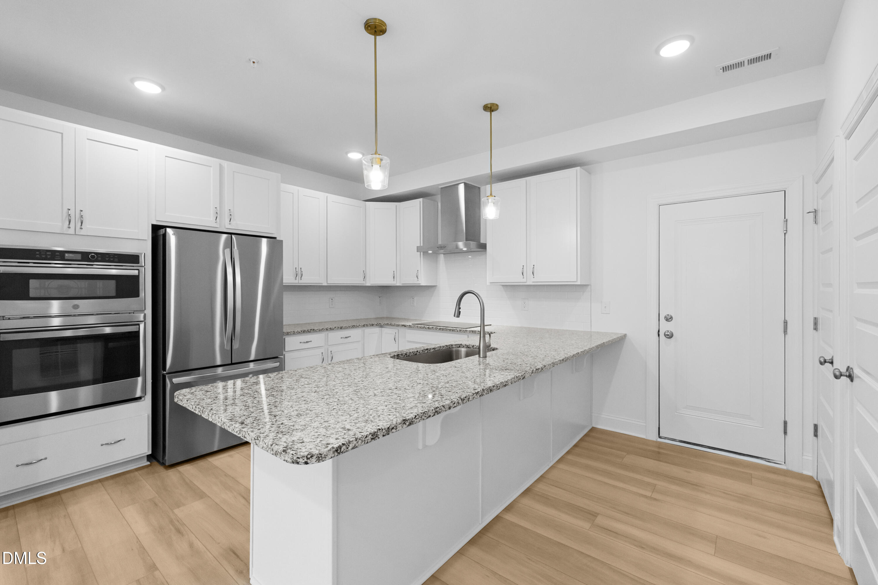 1206 Coach Station Alley Raleigh, NC 27601 - Photo 12 of 38 a kitchen with stainless steel appliances granite countertop a sink refrigerator and microwave