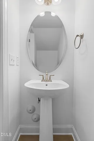 a bathroom with a sink and mirror