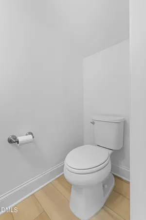 a white toilet sitting next to a shower