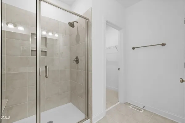 a bathroom with a shower and a glass door
