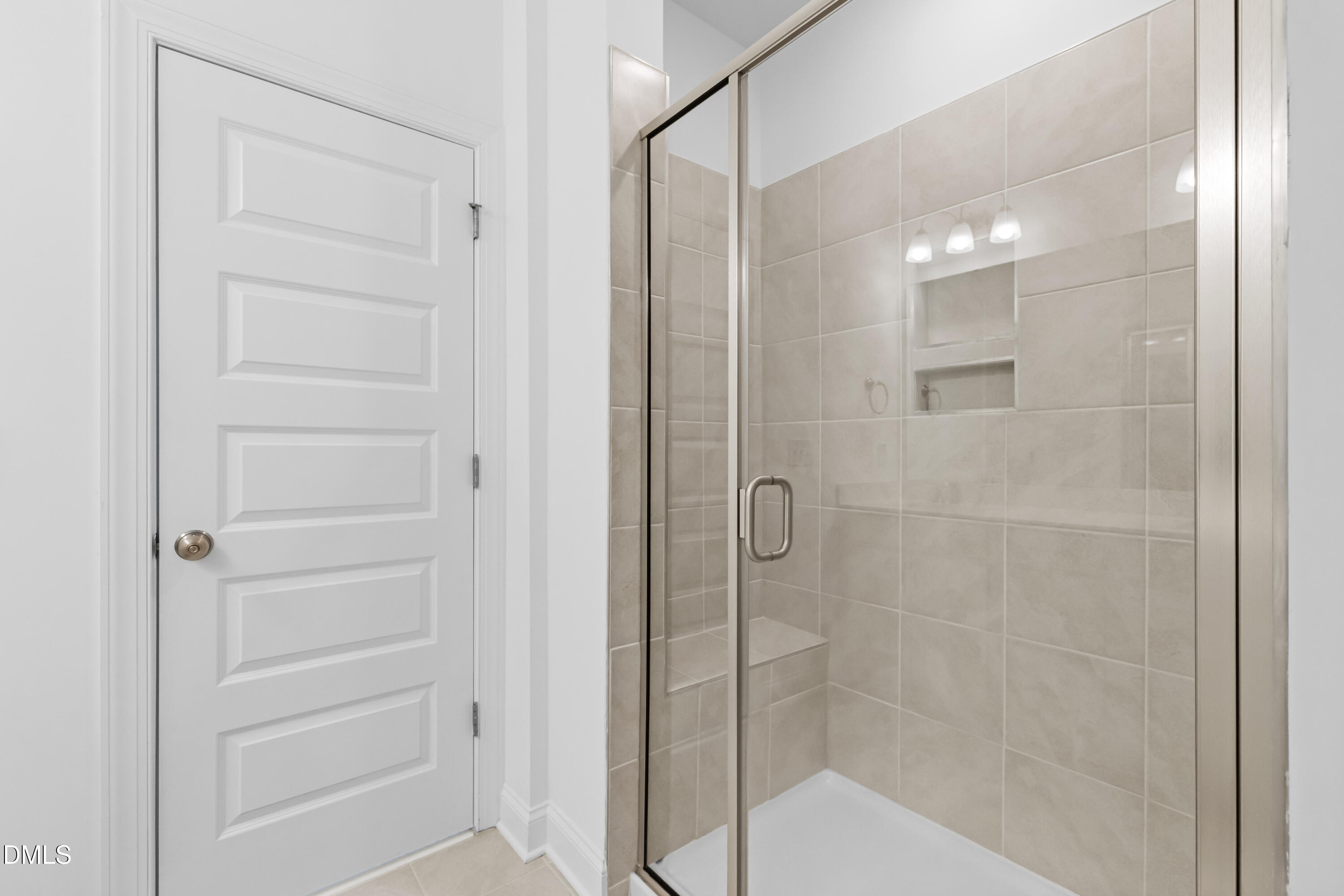 1206 Coach Station Alley Raleigh, NC 27601 - Photo 27 of 38 a bathroom with a shower and a glass door