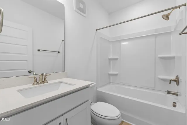 an empty room with a ceiling fan and shower