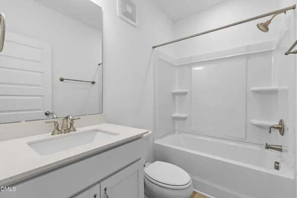 an empty room with a ceiling fan and shower