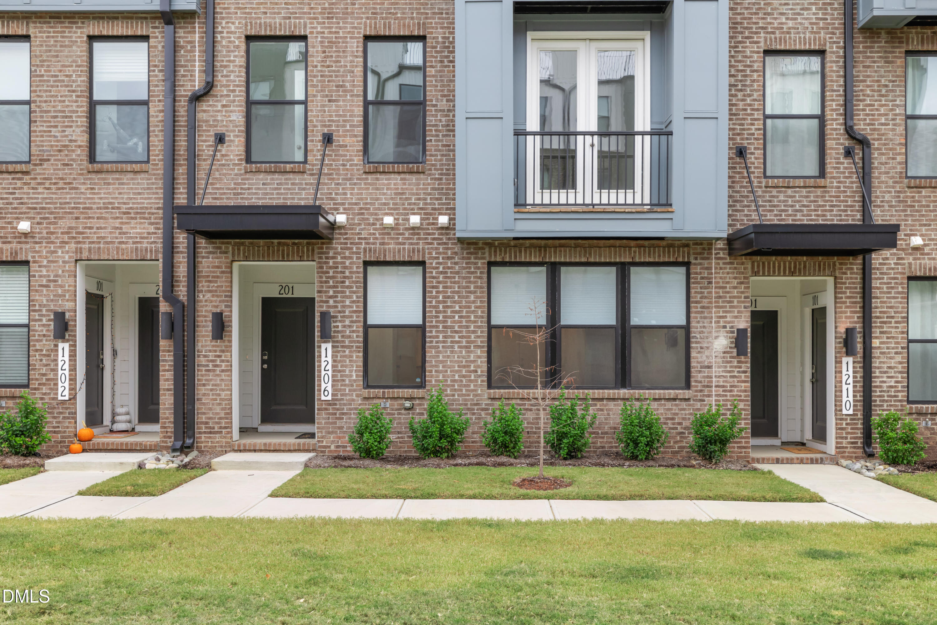 1206 Coach Station Alley Raleigh, NC 27601 - Photo 6 of 38 a front view of a building with a garden and plants