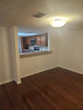 a view of a kitchen with wooden floor and a sink