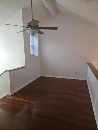 a view of a room with wooden floor and white walls