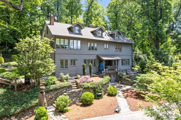 a front view of a house with garden