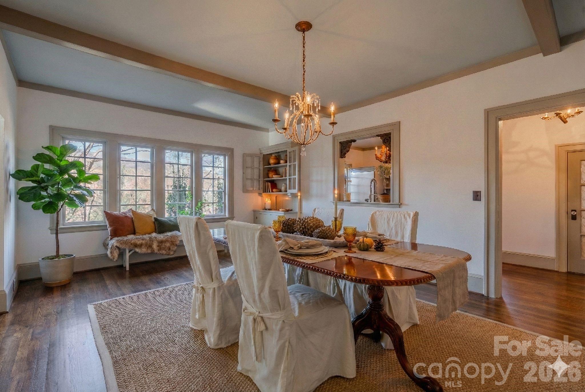 66 Fox Trot Lane Tryon, NC 28782 - Photo 13 of 48 a dining room with furniture potted plants and wooden floor