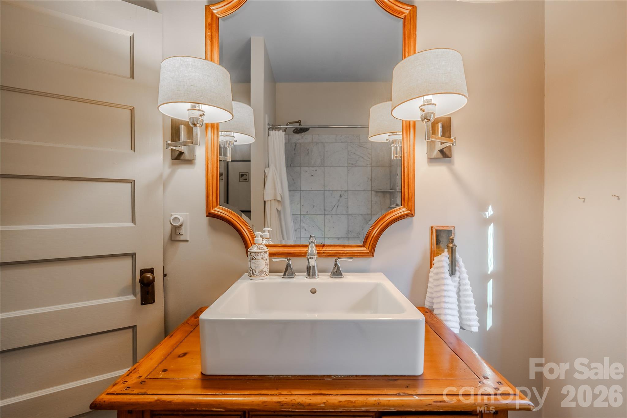 66 Fox Trot Lane Tryon, NC 28782 - Photo 39 of 48 a bathroom with a sink a mirror and a shower