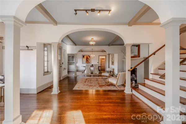 a kitchen with stainless steel appliances granite countertop a refrigerator and a wooden floor