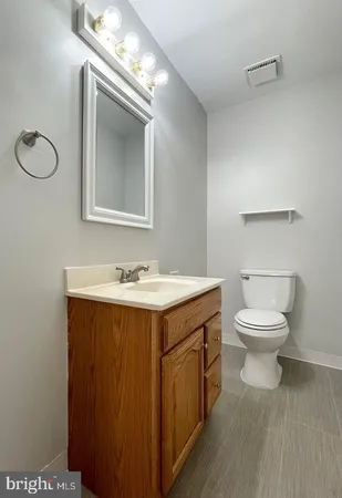 a bathroom with a toilet sink and mirror