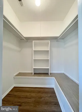 a view of a room with wooden floor and closet
