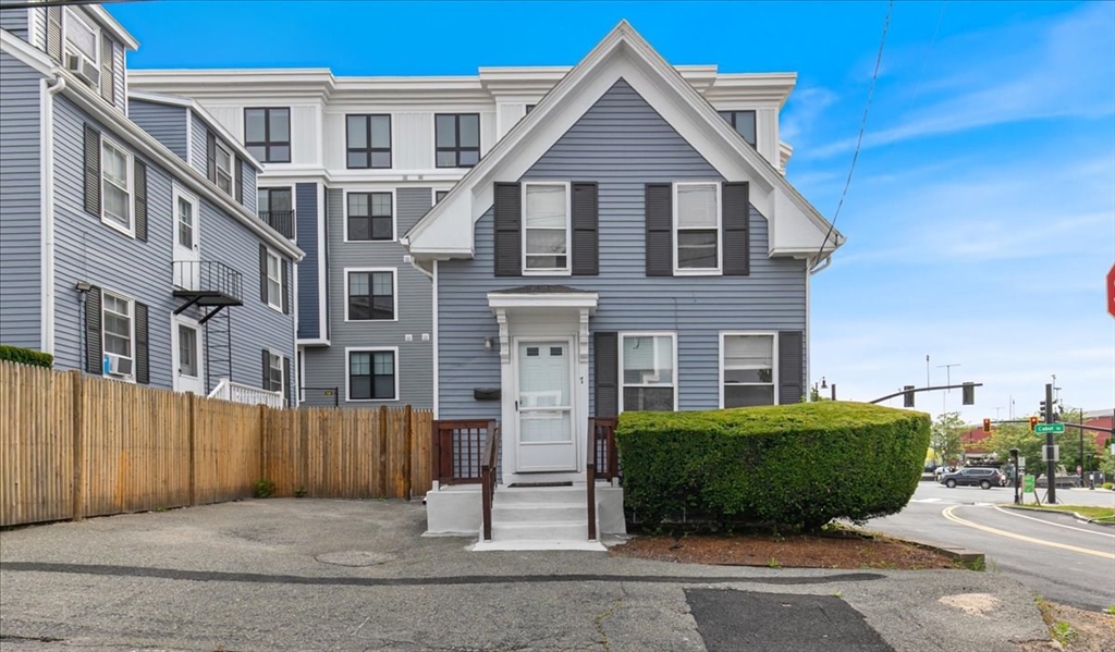 a view of a brick house next to a yard