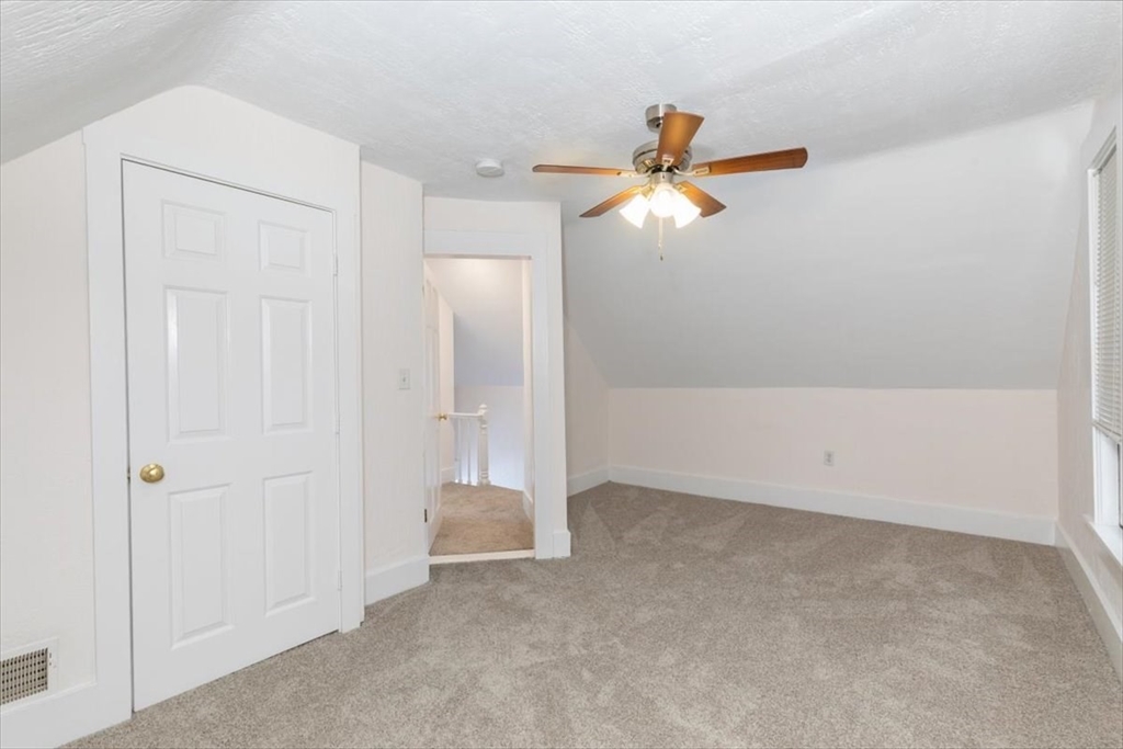 7 Cox Court Beverly, MA 01915 - Photo 15 of 23 an empty room with closet and a chandelier fan