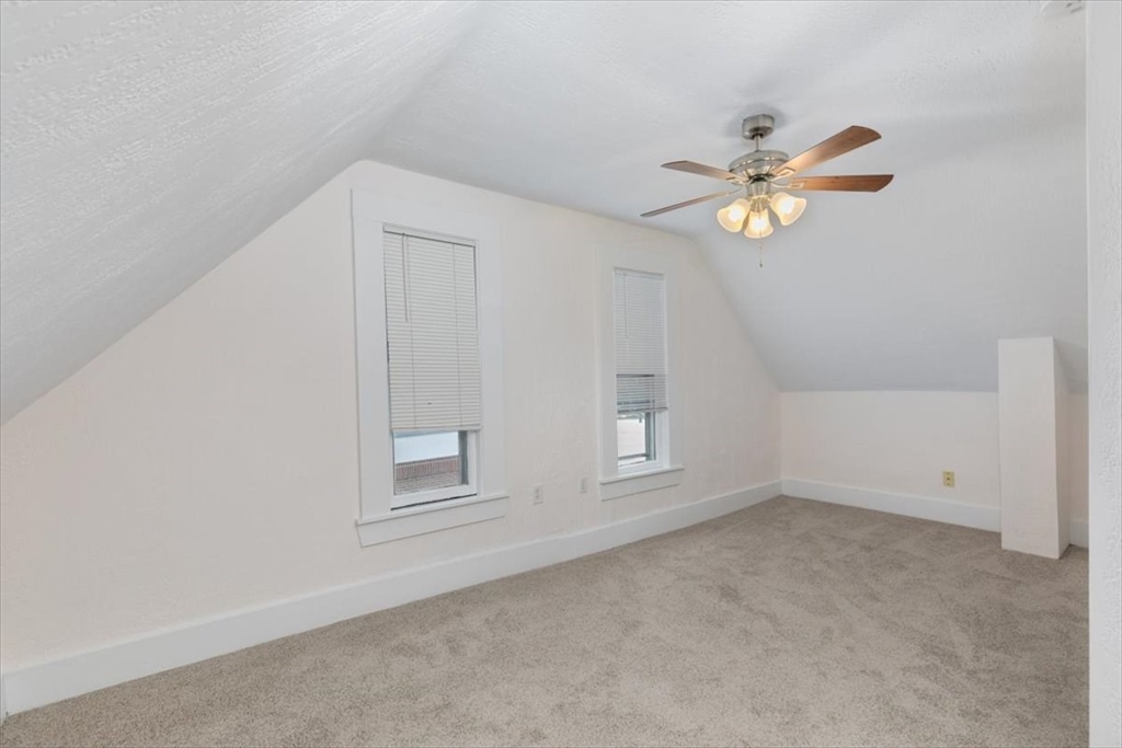 7 Cox Court Beverly, MA 01915 - Photo 16 of 23 an empty room with windows and ceiling fan