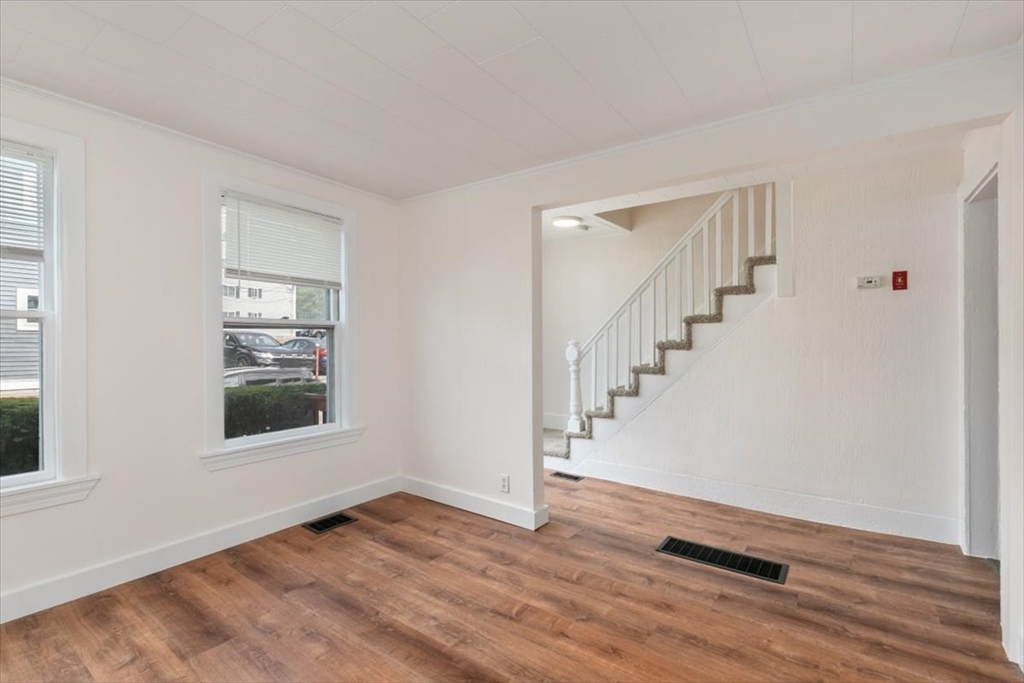 7 Cox Court Beverly, MA 01915 - Photo 4 of 23 a view of an empty room with wooden floor and a window