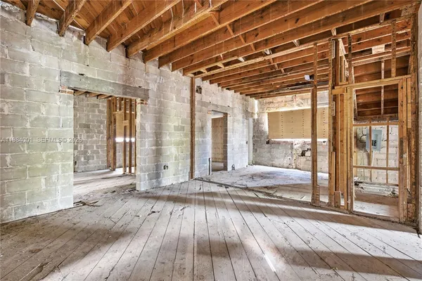 a view of a room with wooden floor and iron stairs