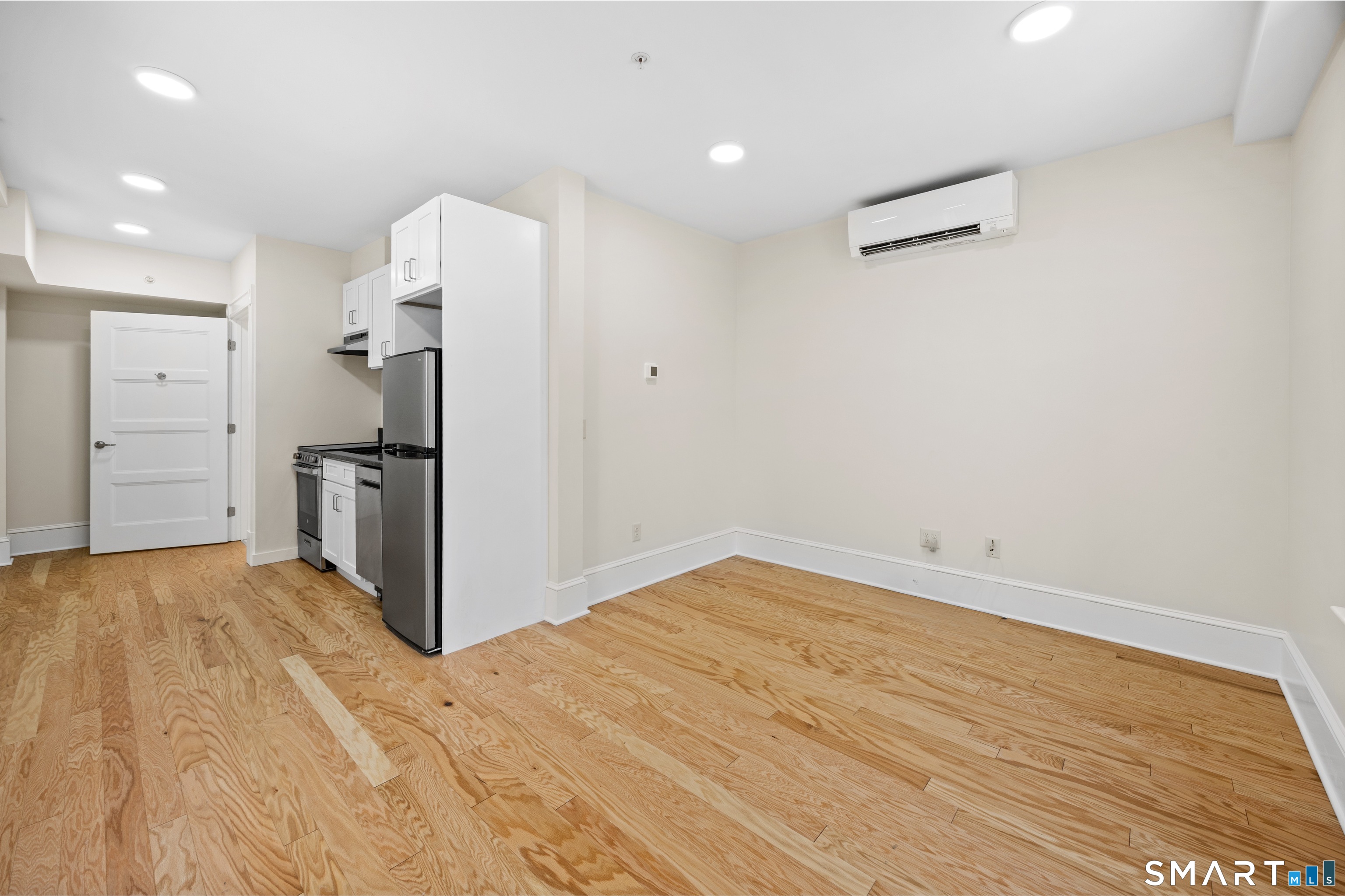 1355 Main Street, Unit 405 Hartford, CT 06103 - Photo 4 of 11 a view of a kitchen with refrigerator and wooden floor