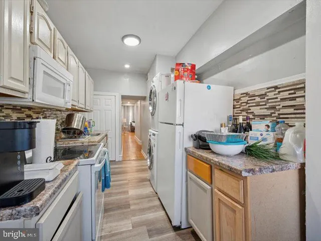 a kitchen with stainless steel appliances granite countertop a stove and a refrigerator