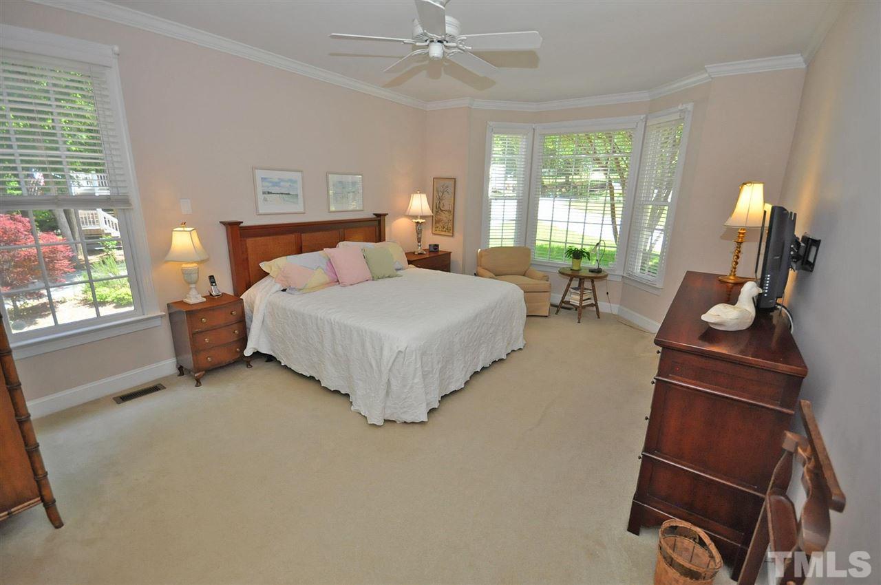 4 Trafalgar Place Durham, NC 27707 - Photo 12 of 27 a bedroom with a bed a couch and windows
