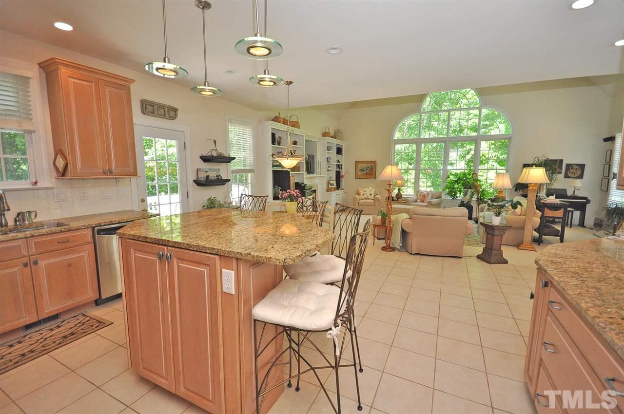 4 Trafalgar Place Durham, NC 27707 - Photo 6 of 27 a large kitchen with kitchen island granite countertop a large counter top space a sink appliances and cabinets