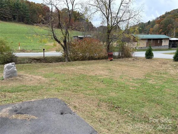 a view of yard with tree in front of it